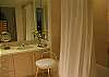 Features two sinks and shower, tub combination.
