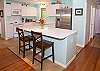 Remodeled kitchen includes updated appliances and bar/island seating