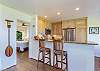 Nicely furnished kitchen, with stools to relax at the bar