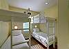 Bunk room #2 is sunny and bright in a soft yellow with double twin over twin bunk beds