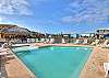 Community pool with cozy sunbeds and a tropical ambiance.