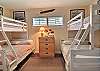 Unwind after a day of beach adventures in the second bedroom with two twins over full bunk beds