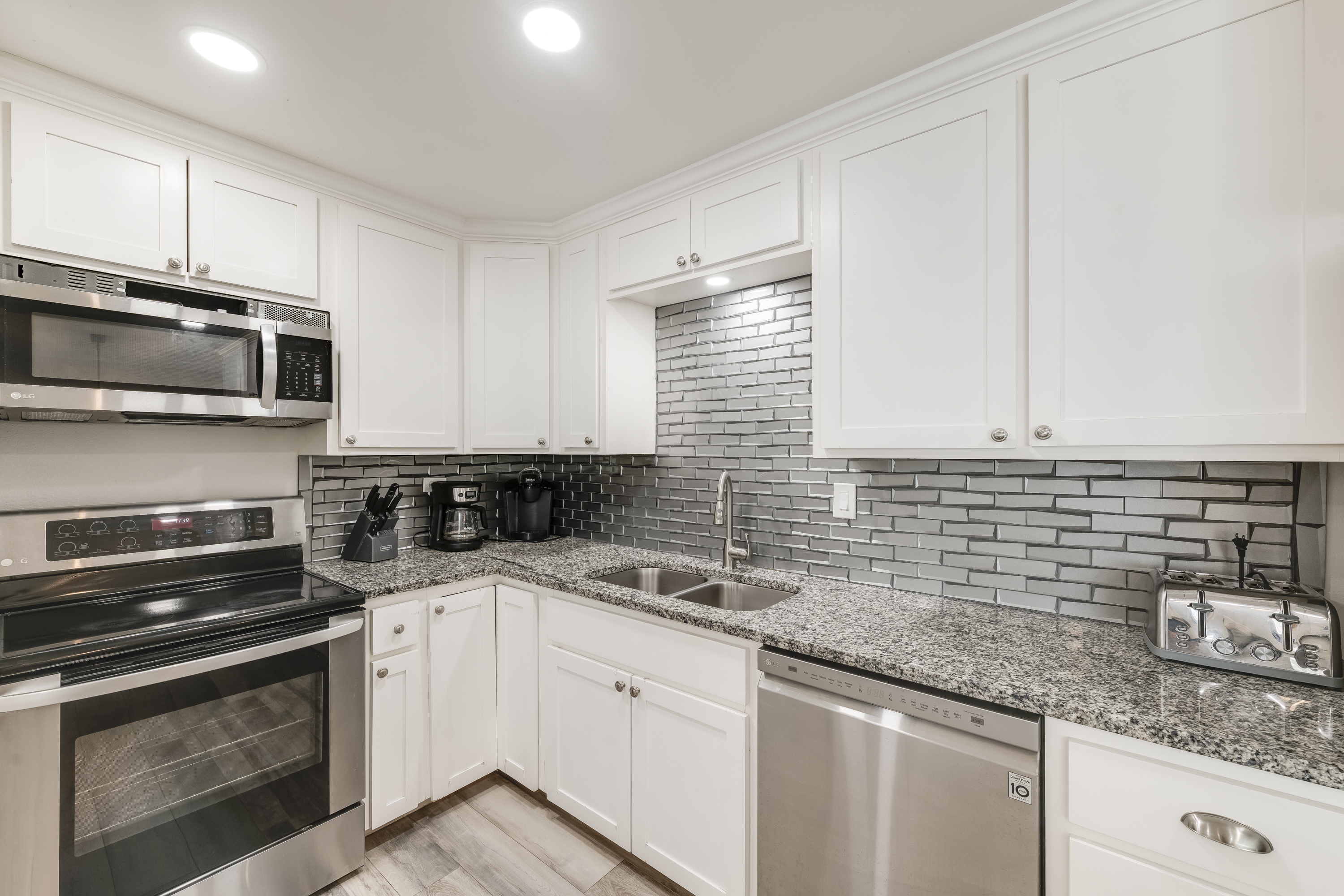 Modern, compact kitchen featuring sleek stainless steel appliances, perfect for efficient cooking and entertaining