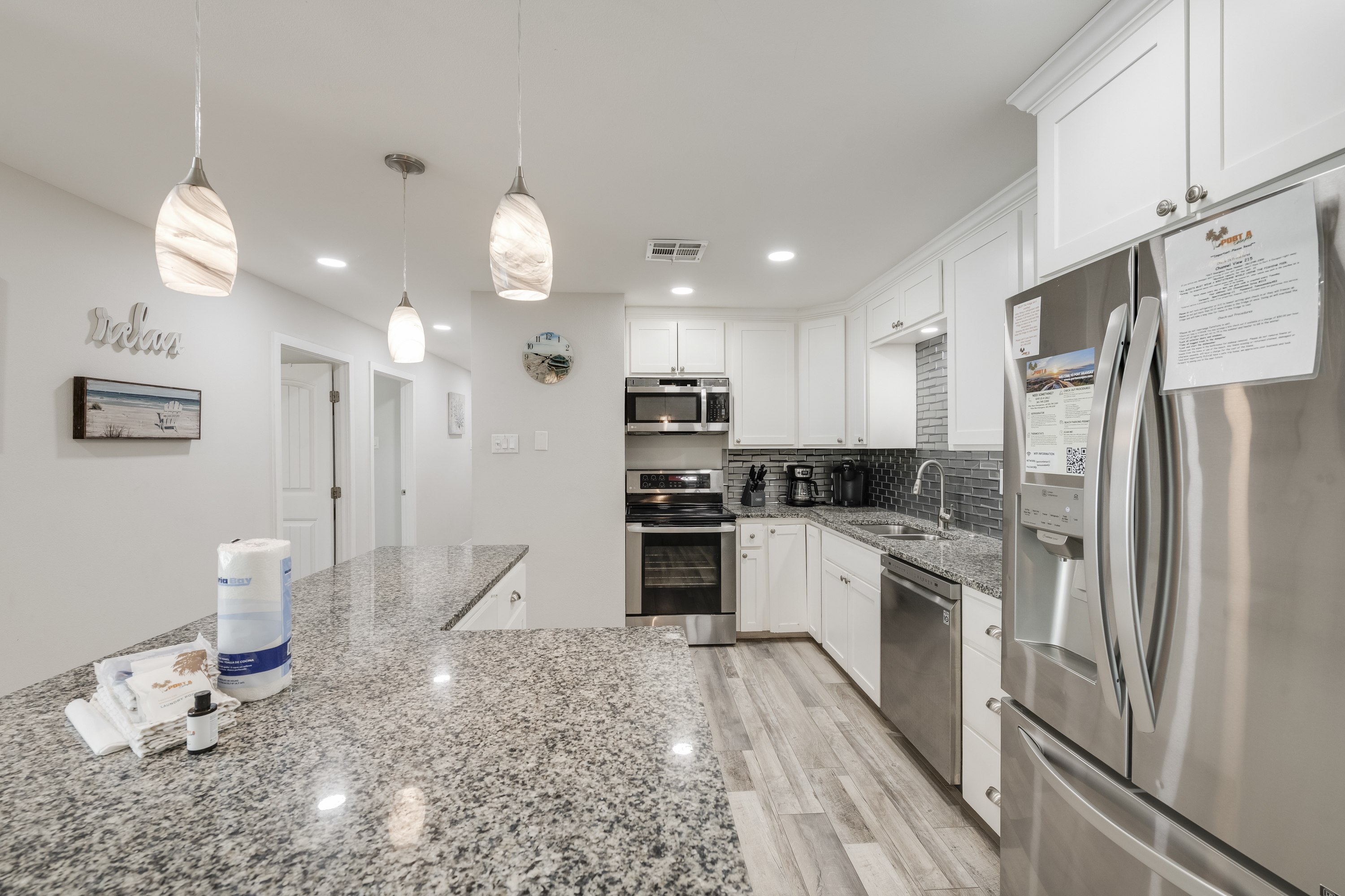 Modern kitchen with a granite countertop island and stainless steel appliances 