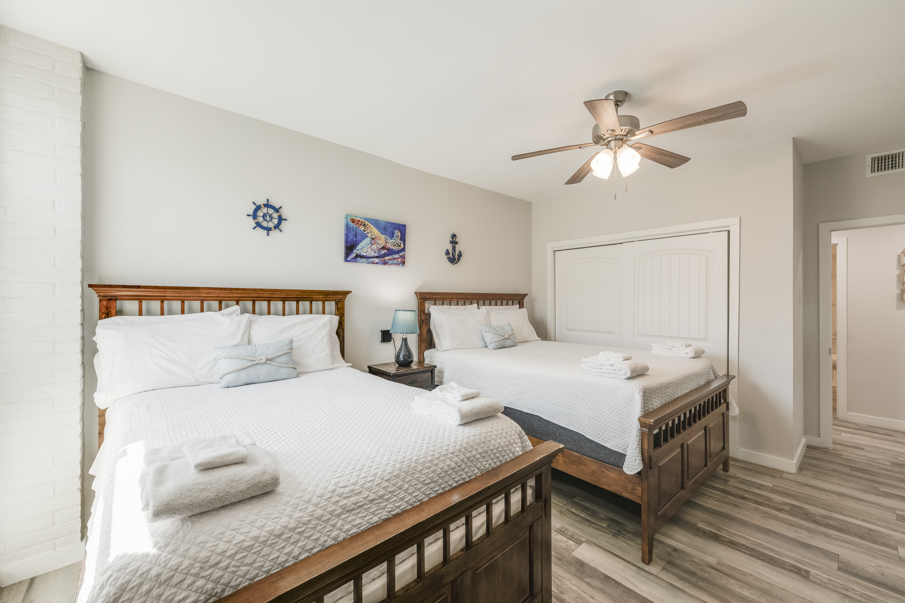 Charming third bedroom equipped with 2 full size beds, designed for maximum comfort and space efficiency.