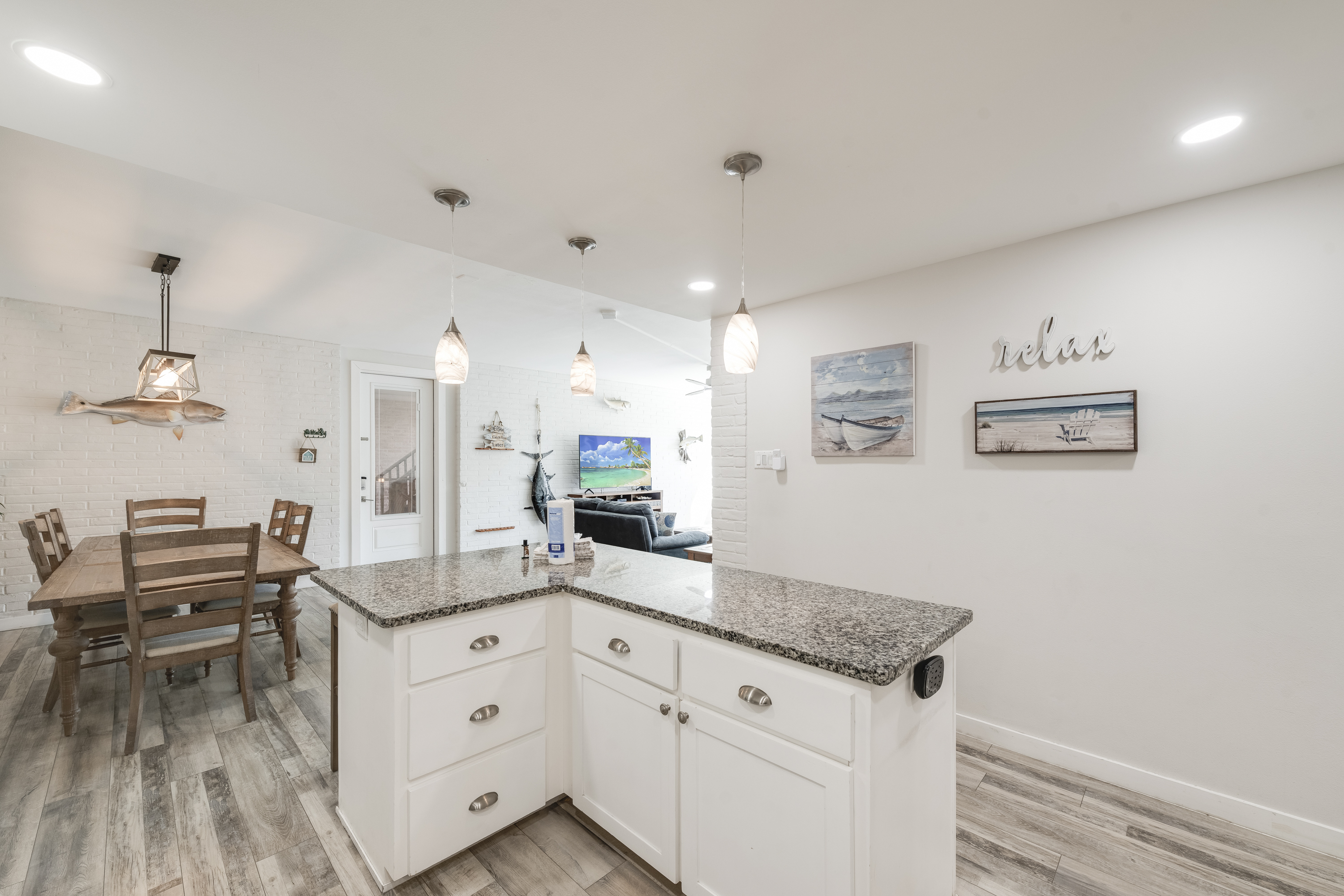 Bright open-concept kitchen and dining area with a modern coastal design