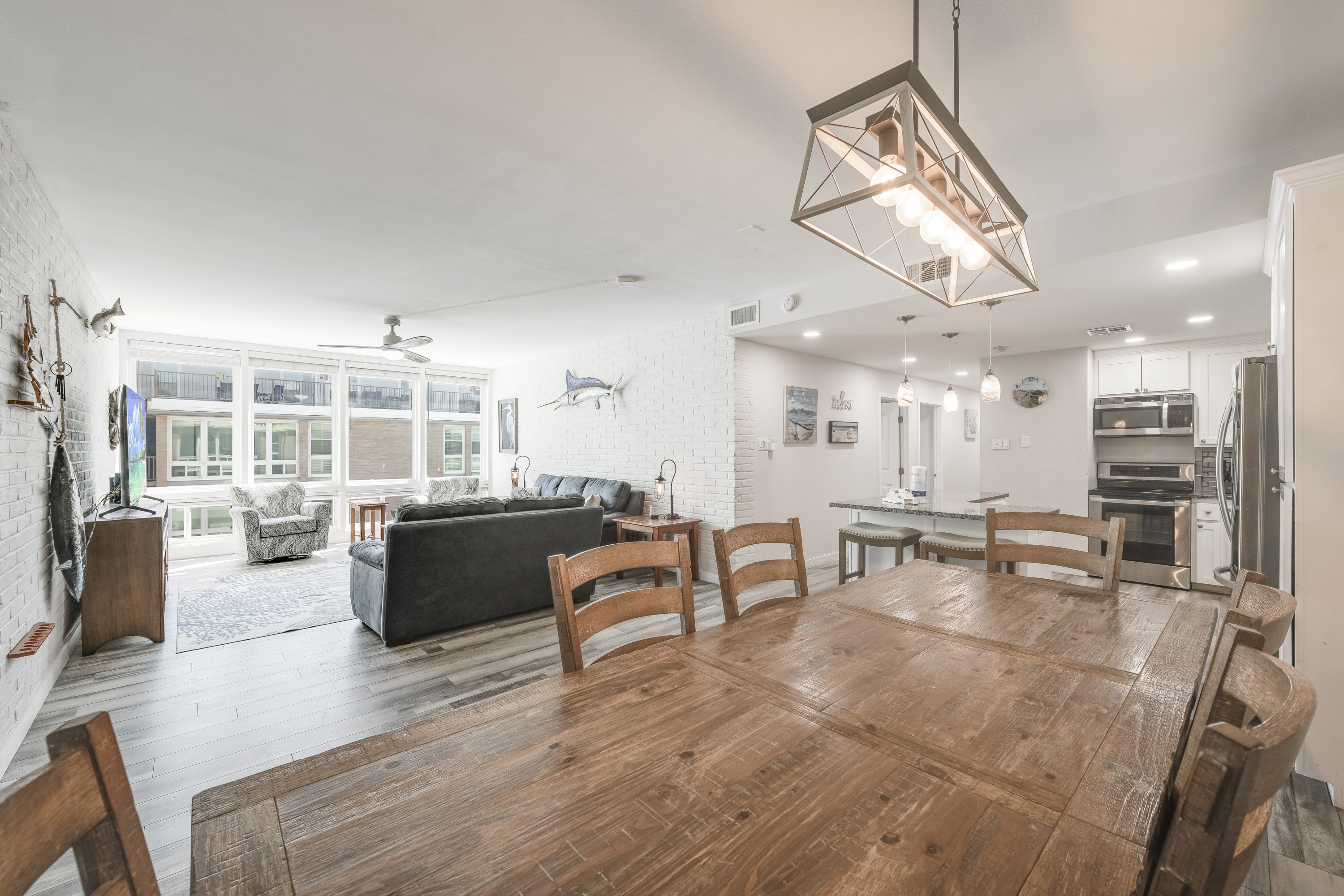 Open-concept living, dining, and kitchen area with dining table that seats 6