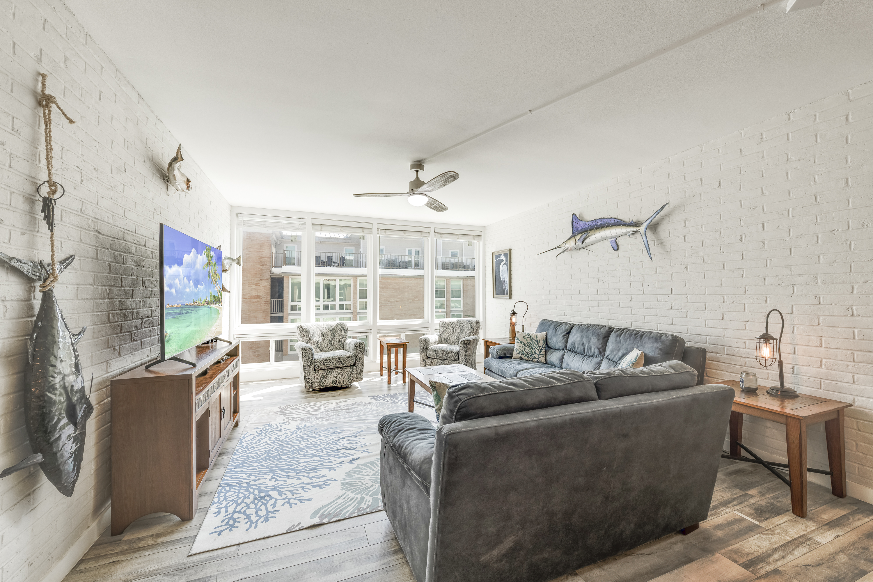 Bright, contemporary living room with comfortable seating and a large flat screen TV