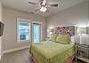 Bright and airy Queen Bedroom with ceiling fan and balcony access