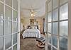 French doors lead you into the luxurious queen suite