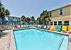 Inviting community pool with clear blue water, surrounded by comfy loungers