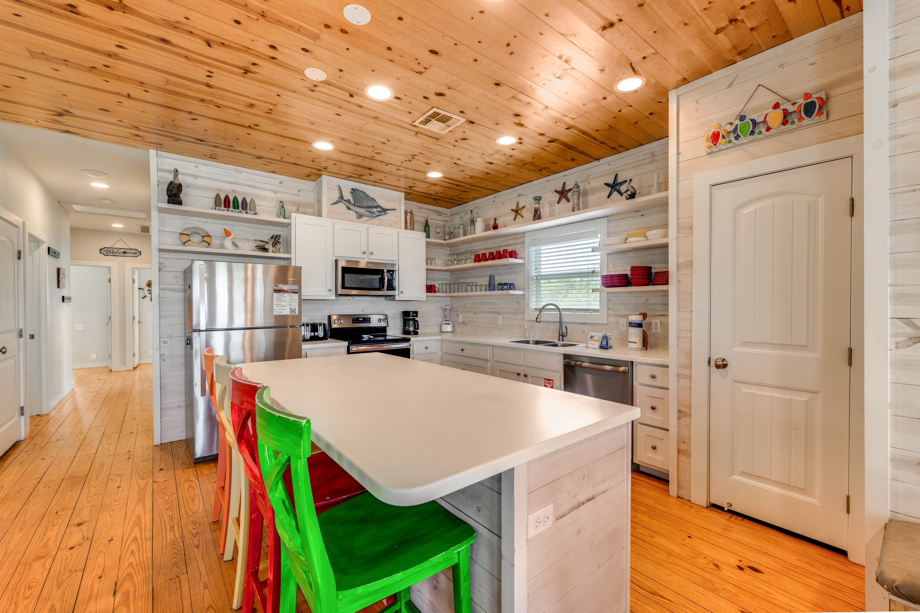 Gather at the island for cocktails and conversation- Seats 4