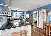 Kitchen with gleaming counters and costal accents