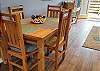 Rustic wooden dining table with coastal accents and seating for 4