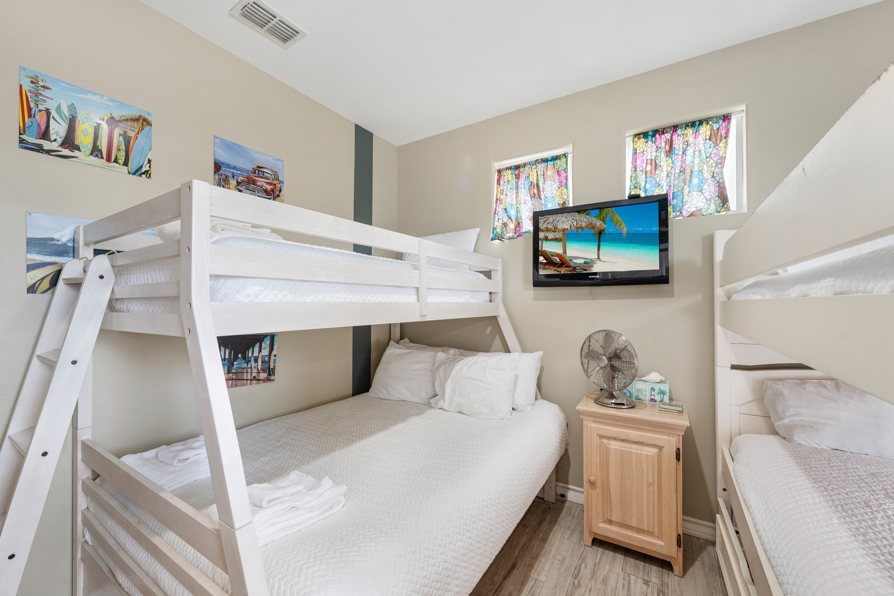 A bright, cheerful bunk space where the fun continues long after sunset. One set twin over twin, One set twin over full, and mounted TV in this Bunk Room