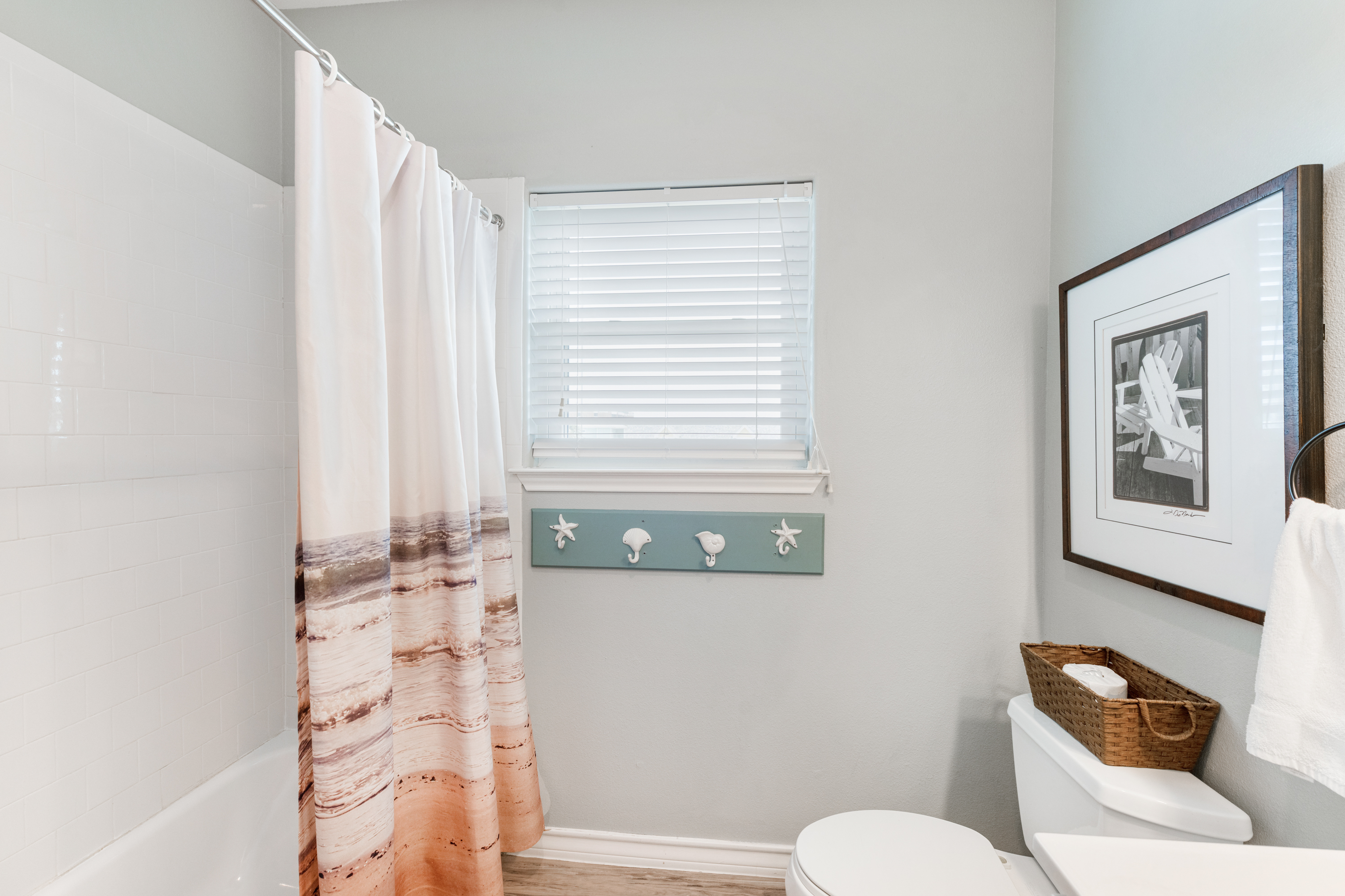 Second freshly updated full bath with coastal charm, stocked with soft towels and essentials for your stay.