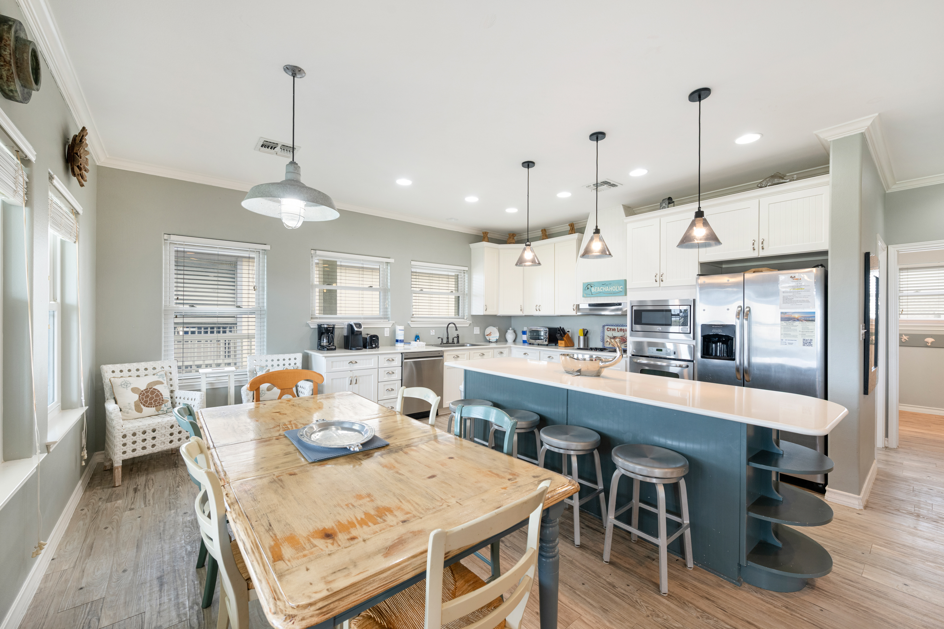 Share meals and laughter in the stylish dining area, enhanced by the coastal ambiance. Seating for six at table and four more at counter.