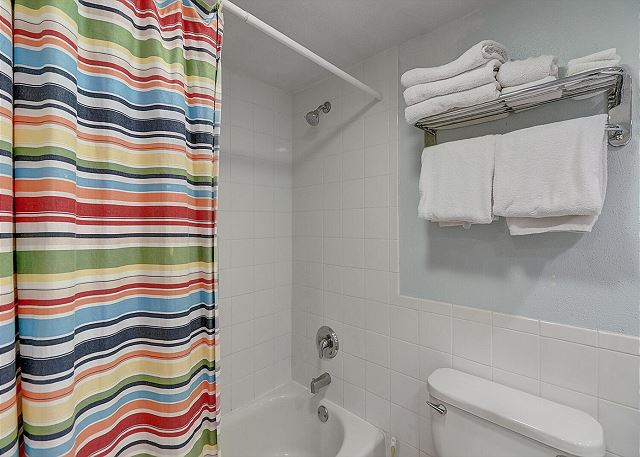 En suite bathroom with a fun shower curtain! 