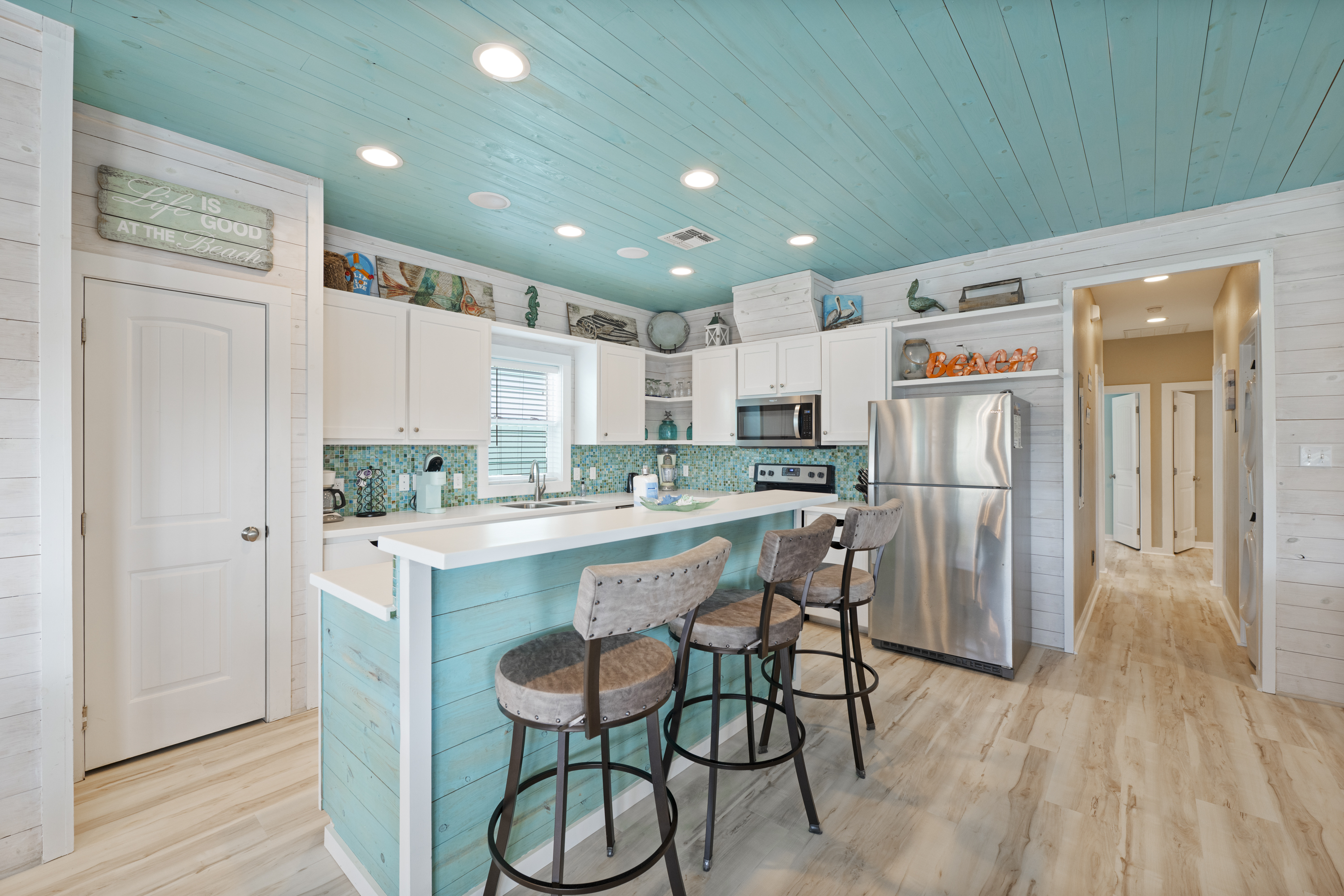 The open-concept kitchen flows seamlessly into the living area, making it easy to cook and stay connected with family and friends. The breakfast bar provides additional seating—perfect for morning coffee, quick meals, or chatting with the cook while dinne