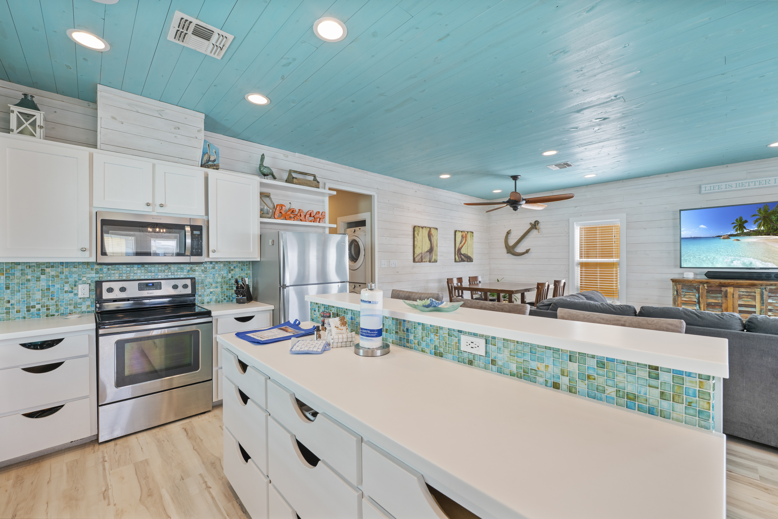 The open-concept kitchen flows seamlessly into the living area, making it easy to cook and stay connected with family and friends. The breakfast bar provides additional seating—perfect for morning coffee, quick meals, or chatting with the cook while dinne