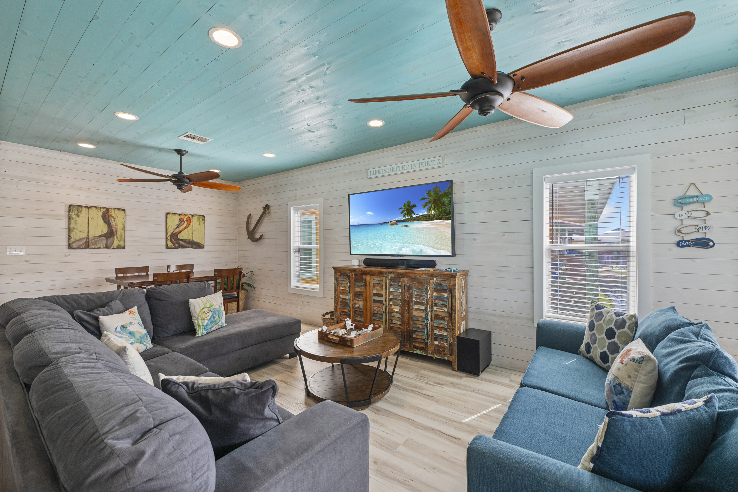 The airy living room features comfortable seating and a relaxed coastal vibe that makes it easy to settle in and feel at home. It''s the perfect spot to cool off after a day in the sun, enjoy your favorite shows on the TV, or gather together to plan the n