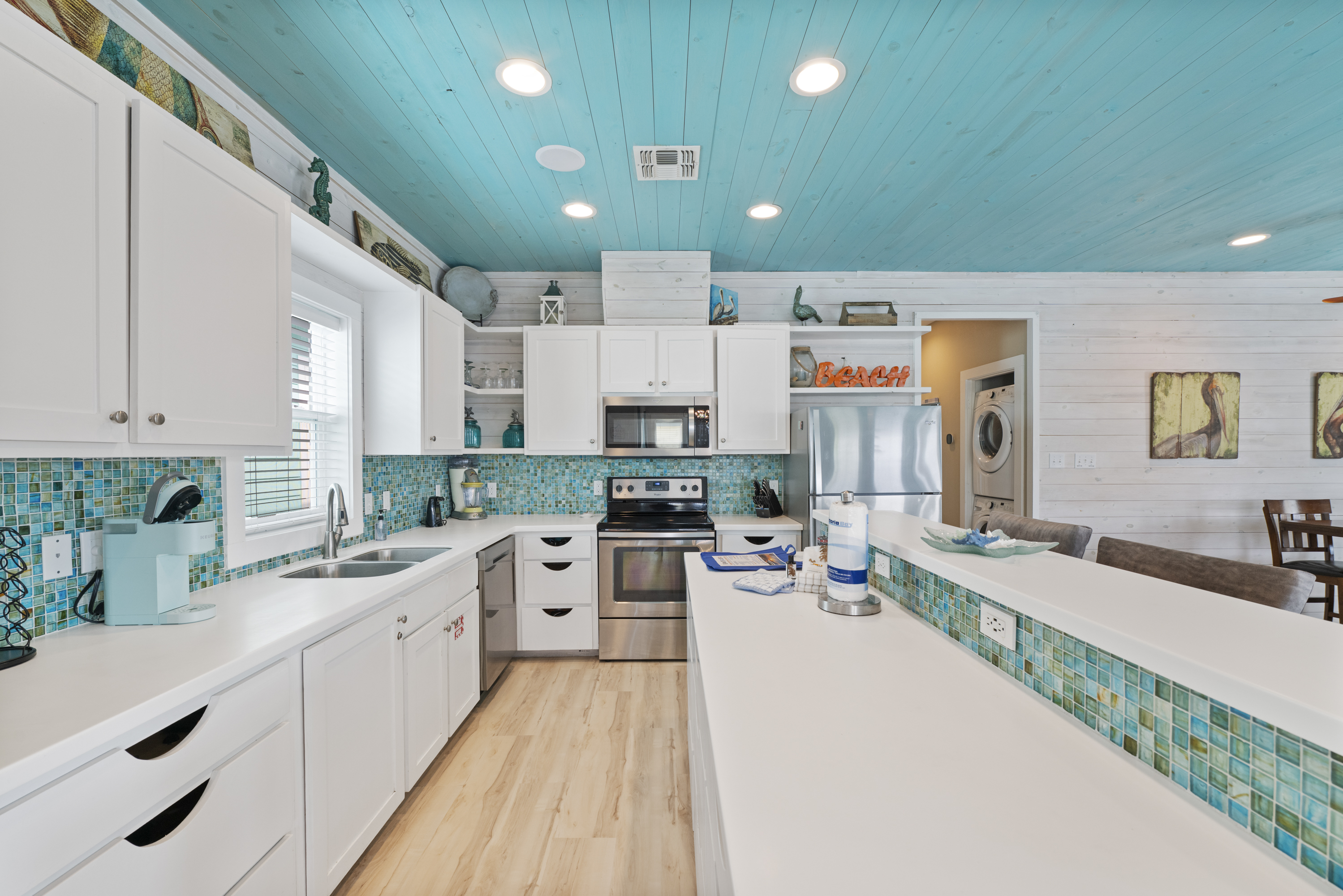 The open-concept kitchen flows seamlessly into the living area, making it easy to cook and stay connected with family and friends. The breakfast bar provides additional seating—perfect for morning coffee, quick meals, or chatting with the cook while dinne