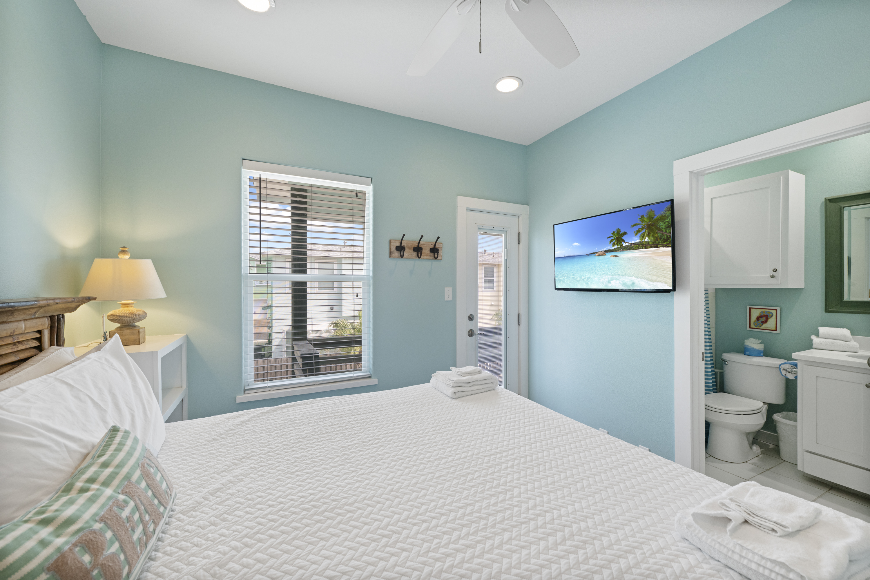 This is the primary bedroom. It has a king sized bed, it''s own bathroom, TV with cable, and a small balcony.