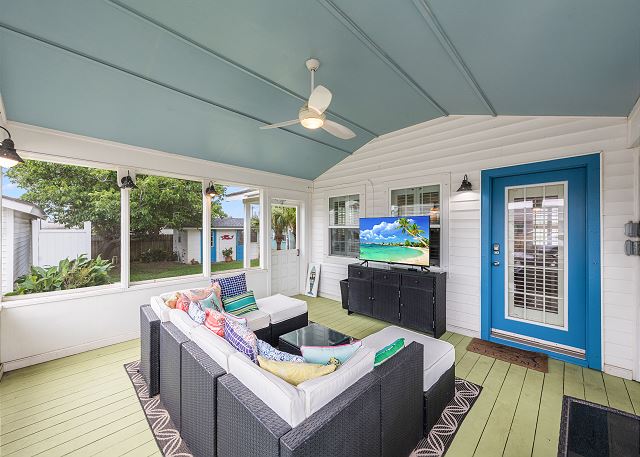 Screened-in porch with sectional seating & a TV!