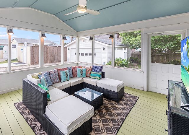 Screened-in porch with sectional seating & a TV!