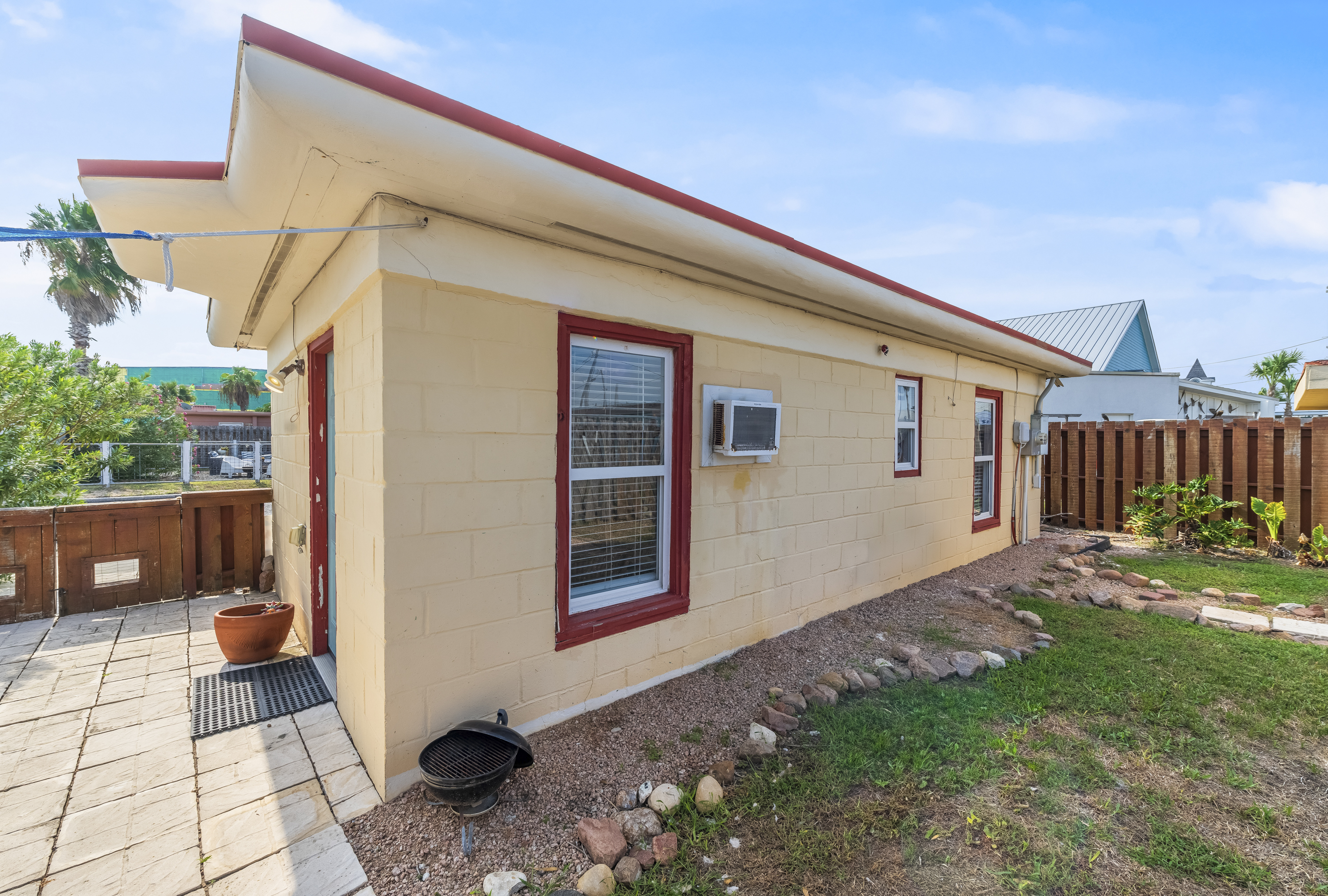 A beach-town gem with backyard charm featuring a charcoal BBQ grill 