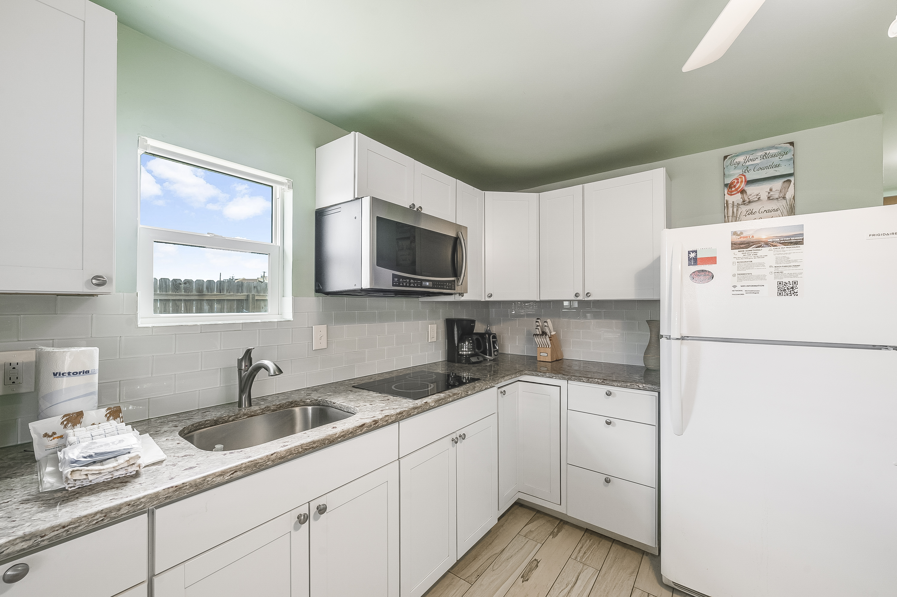Modern amenities meet seaside simplicity featuring a 2 burner hot plate, microwave and drip coffee maker