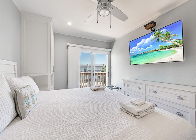 King bedroom with TV and deck access