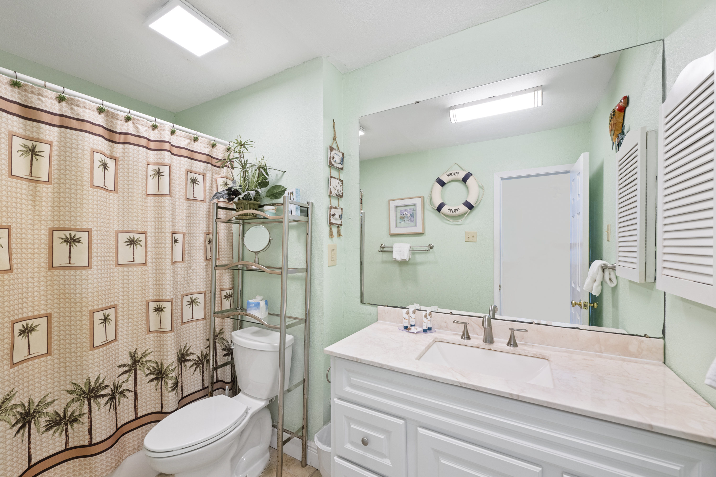 Well-appointed full bathroom stocked with beach-friendly amenities — simple, clean, and comfortable