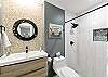 Chic upper-level bathroom with walk-in shower.