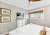 Charming 2nd King bedroom with mounted TV for laid-back coastal comfort