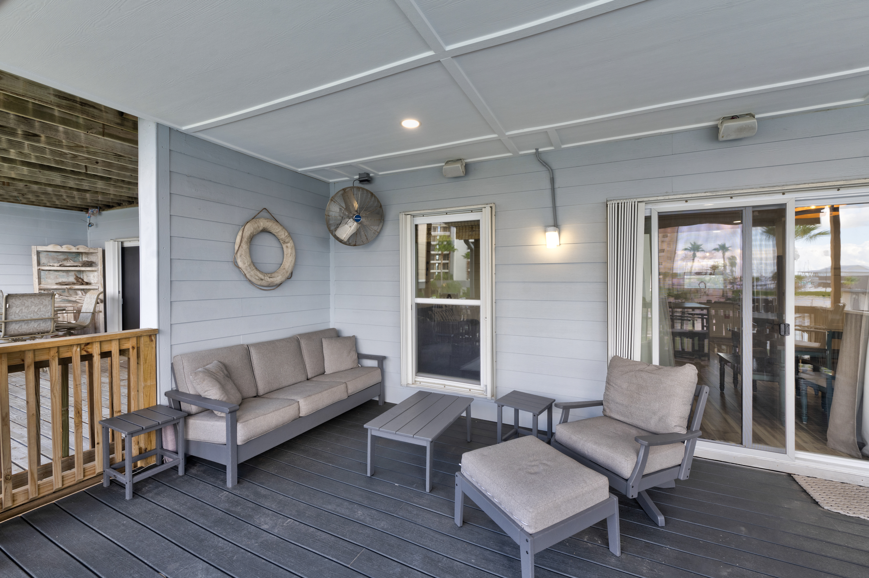 Coastal comfort awaits: furnished deck for lounging and dining.