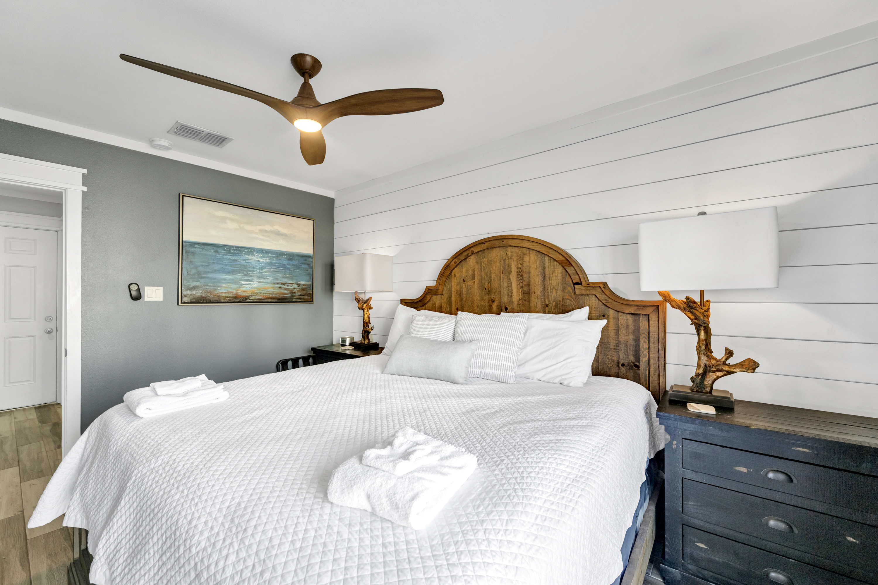 The primary bedroom features a king-size bed, and mounted TV for laid-back coastal comfort