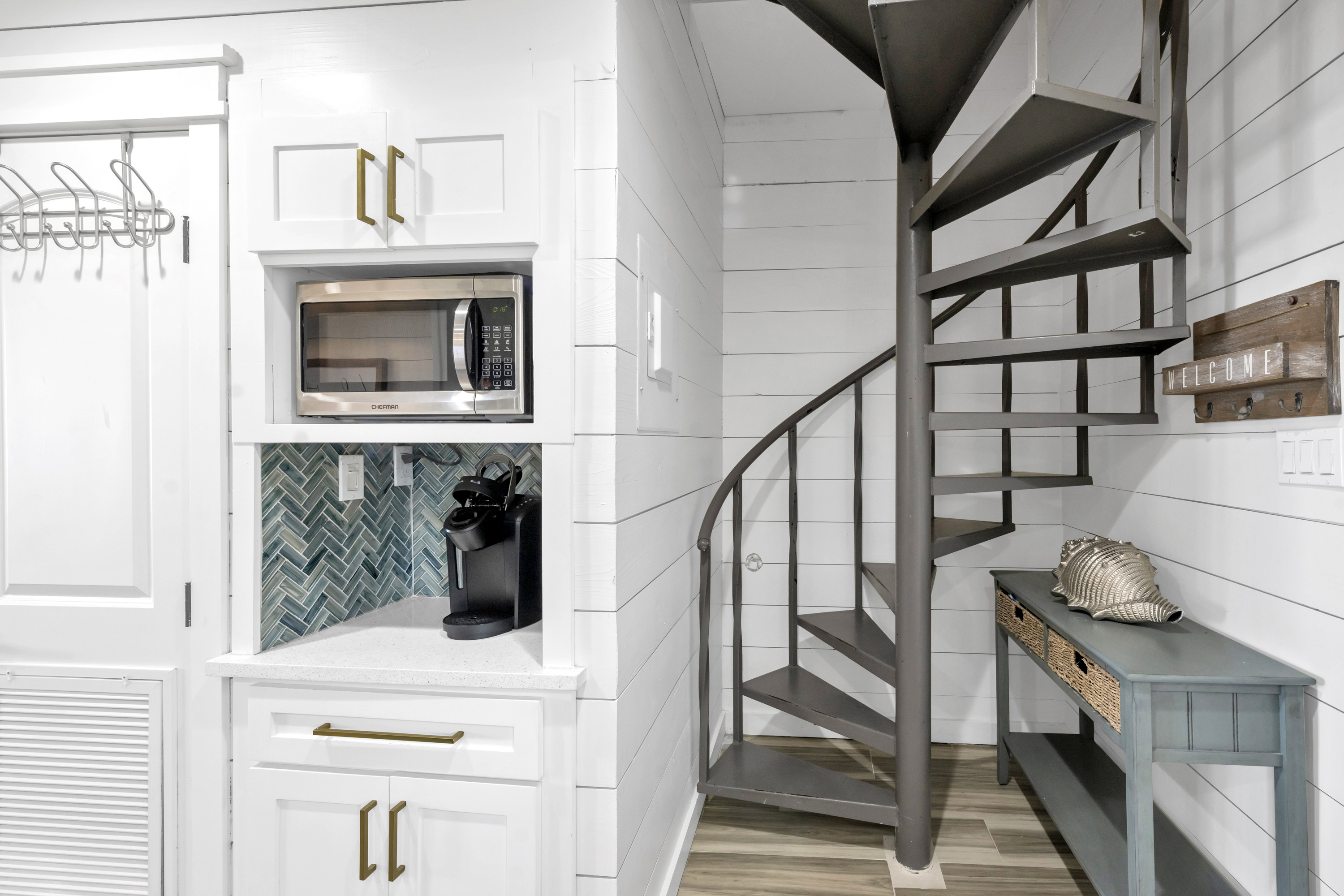 Elegant and functional, the corner spiral staircase guides you to the upper level, amplifying the condo’s open, light-filled character.