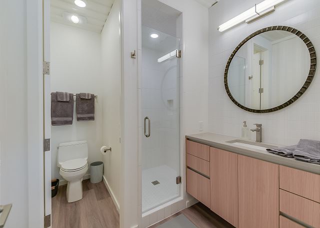 Very well lit bathroom with walk in shower