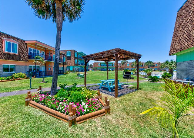 Landscaped grounds with seating and BBQs along path leading you to the beach!