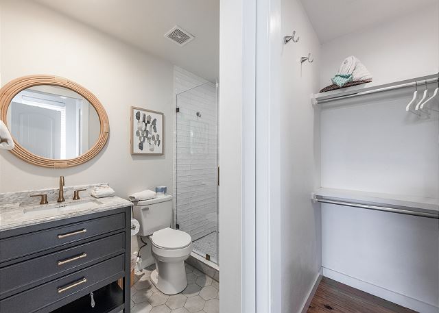 Bathroom with walk in shower and storage space