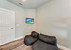 Lounge chairs and wall mounted flat screen in bunk room