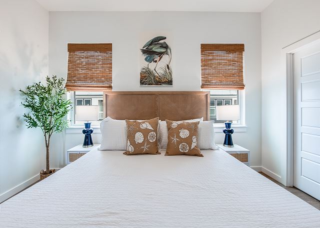 Primary Bedroom with King bed, TV, and ensuite bath with low-entry tiled shower