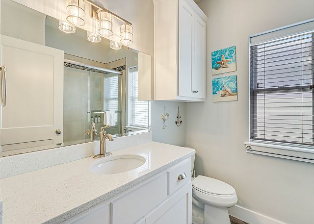 Bathroom with single vanity and tiled shower