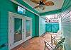 Furnished Breezway with TV and ceiling fans for outdoor relaxation