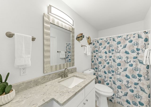 Stylish bathroom boasting a sleek toilet and contemporary sink with ample counter space			