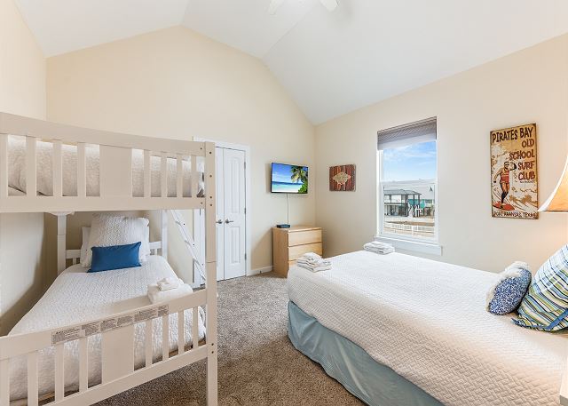 Comfortable bedroom on second floor with a queen-size bed and twin over twin bunk set.