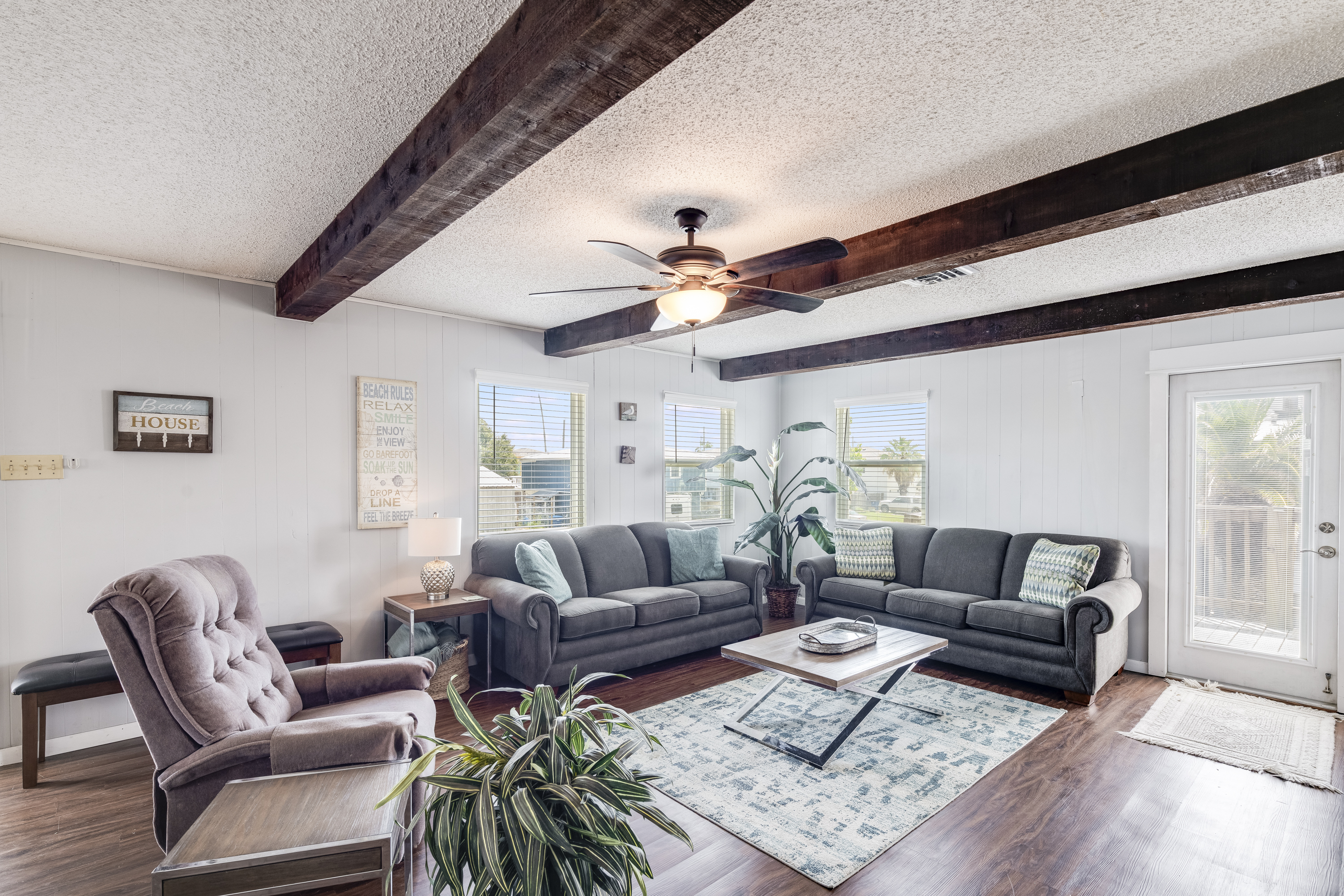 Unwind in a living room designed for comfort, conversation, and coastal vibes