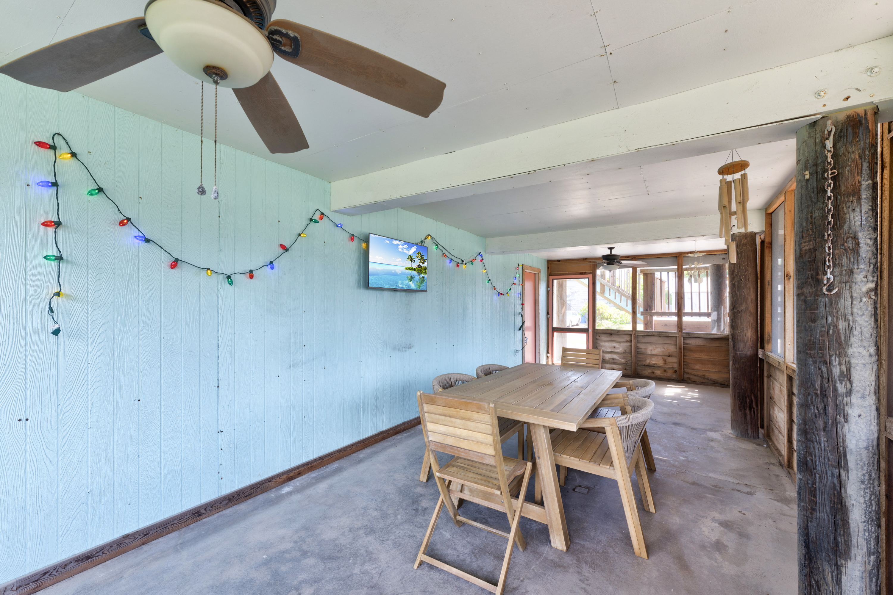 This enclosed patio offers a versatile hangout area designed for making memories in true Port A style