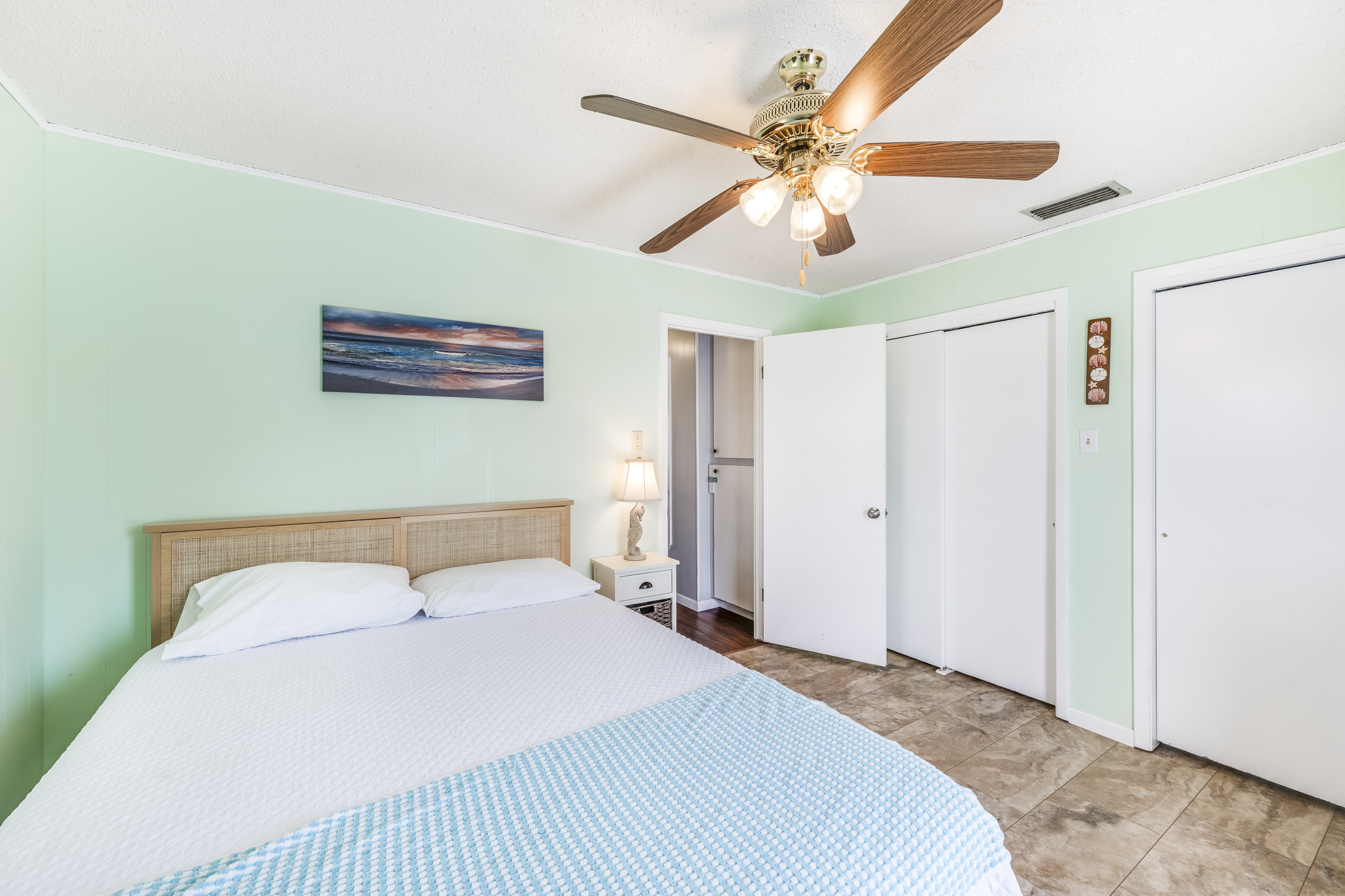 This cozy bedroom offers a comfortable Queen bed and ample closet space